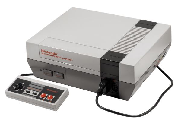 A Nintendo Entertainment System video game console with controller attached.